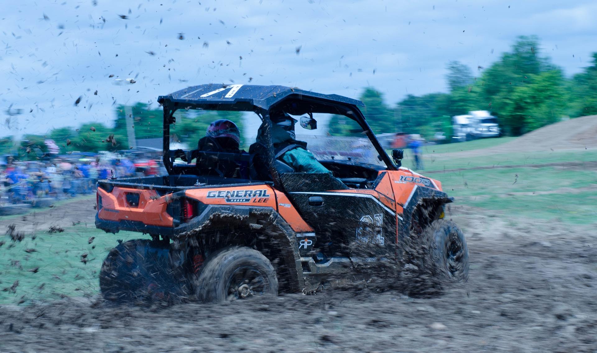 Image of an atv driving in mud
