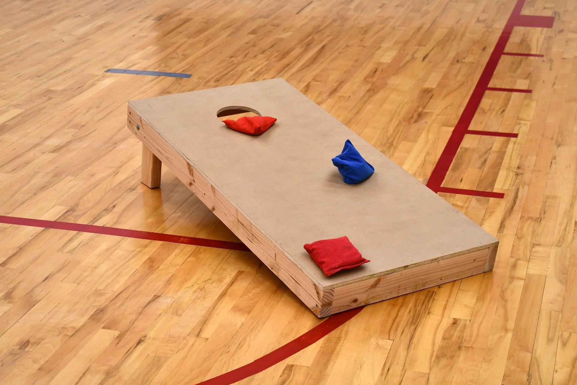 Image of cornhole set with 2 red and 1 blue bean bag