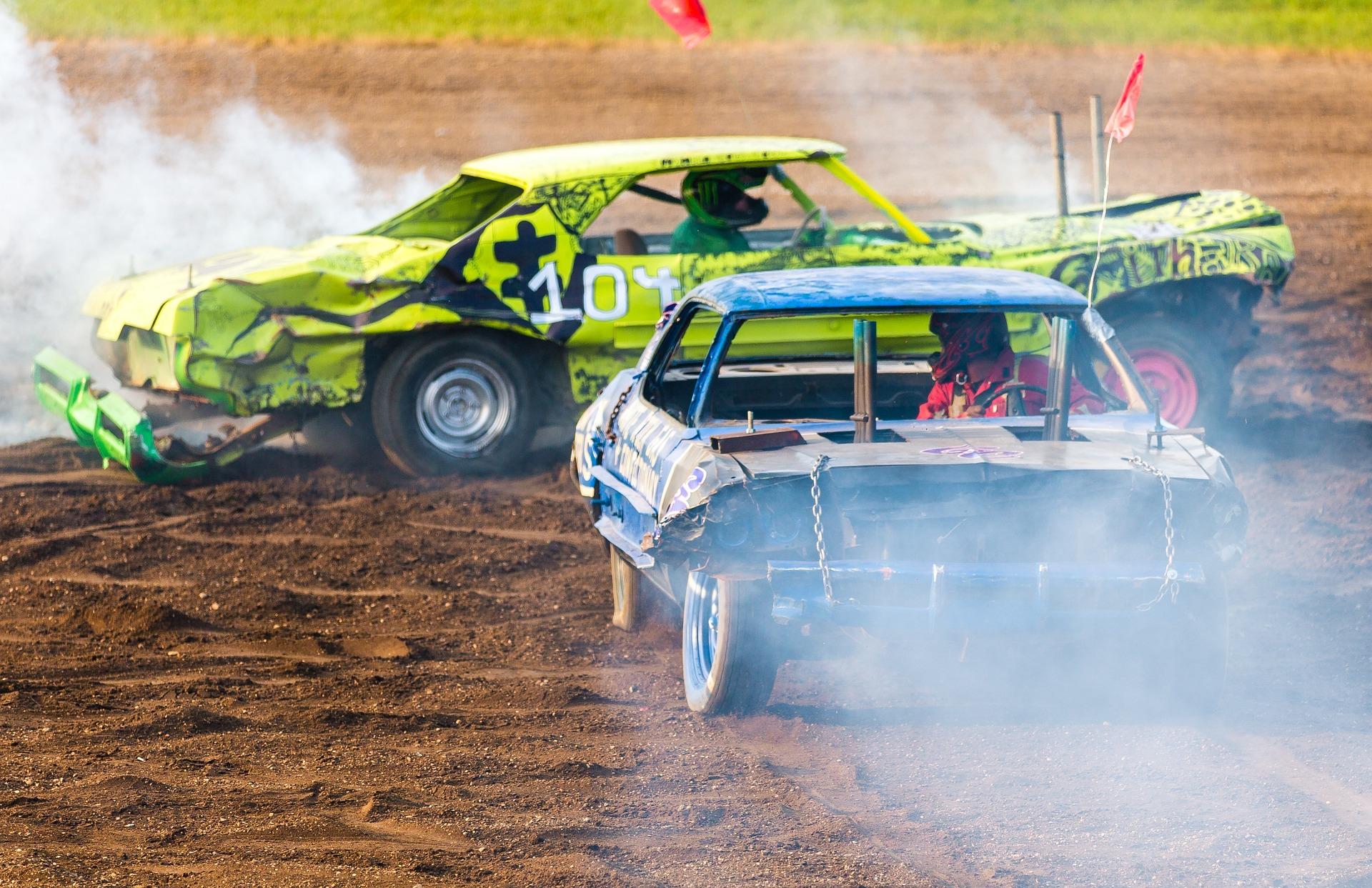 2 cars crashing into each other in the middle of a dirt field