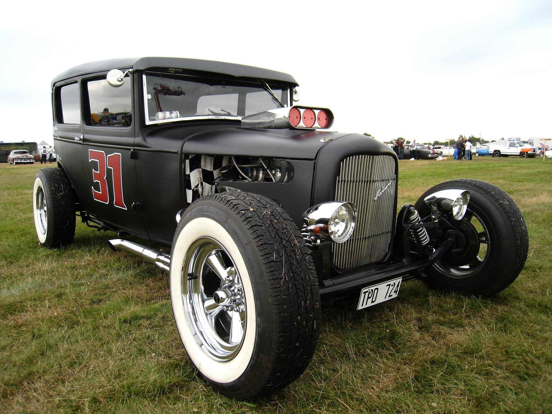 Image of a black classic car with a red number 31