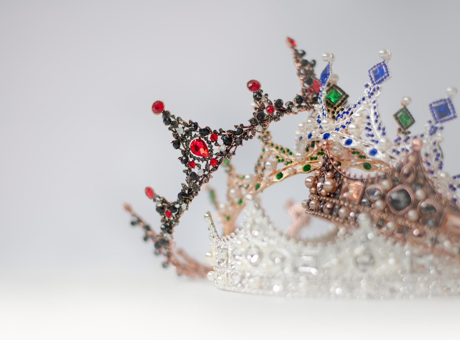 Image of crowns stacked in a pile with a white background